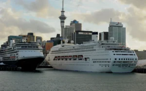 Cruise ships (C) lie tied up at Auckland's Viaduct Harbour during the 2011 Rugby World Cup on October 14, 2011. Auckland in New Zealand's North Island has the largest urban area in the country with just over one million people living there. AFP PHOTO / Greg WOOD (Photo by GREG WOOD / AFP)