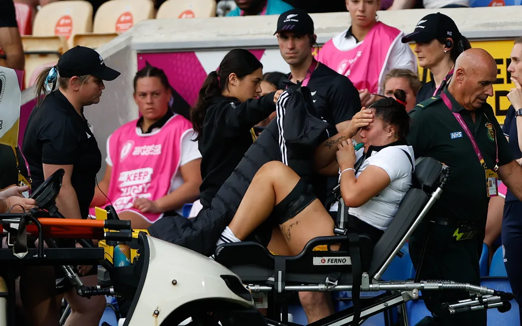 Kalpo Olsen-Baker of New Zealand leaves the pitch with a badly injured leg.