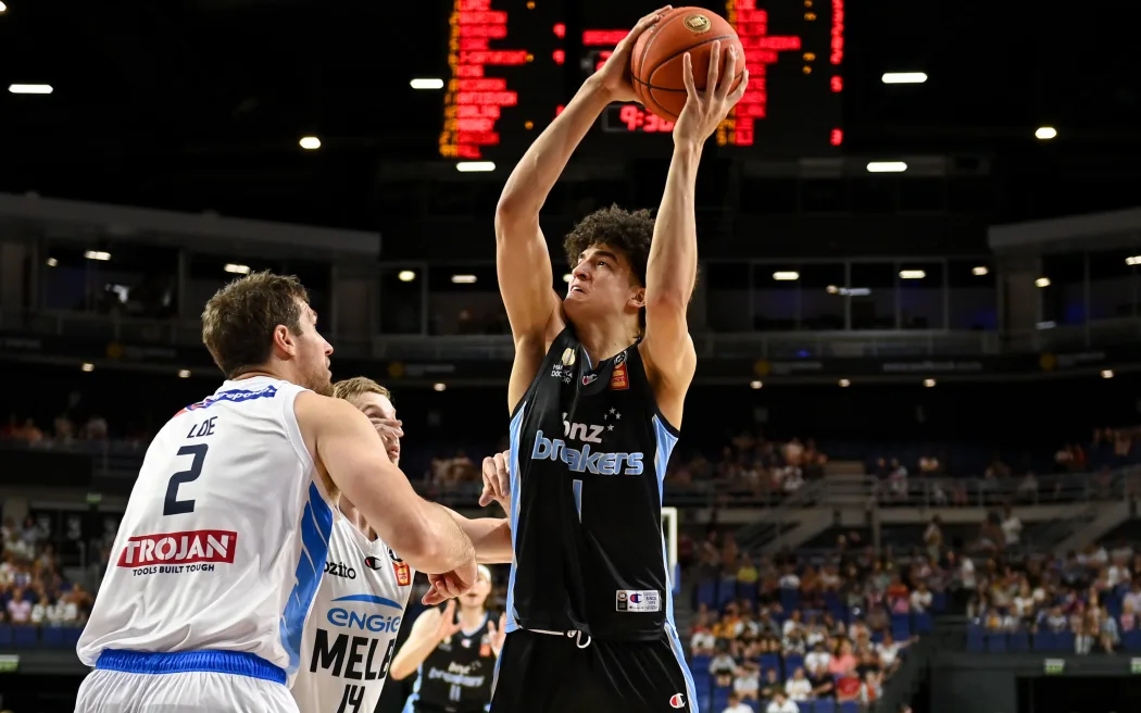 Karim Lopez of the Breakers is blocked by Robert Loe of Melbourne United