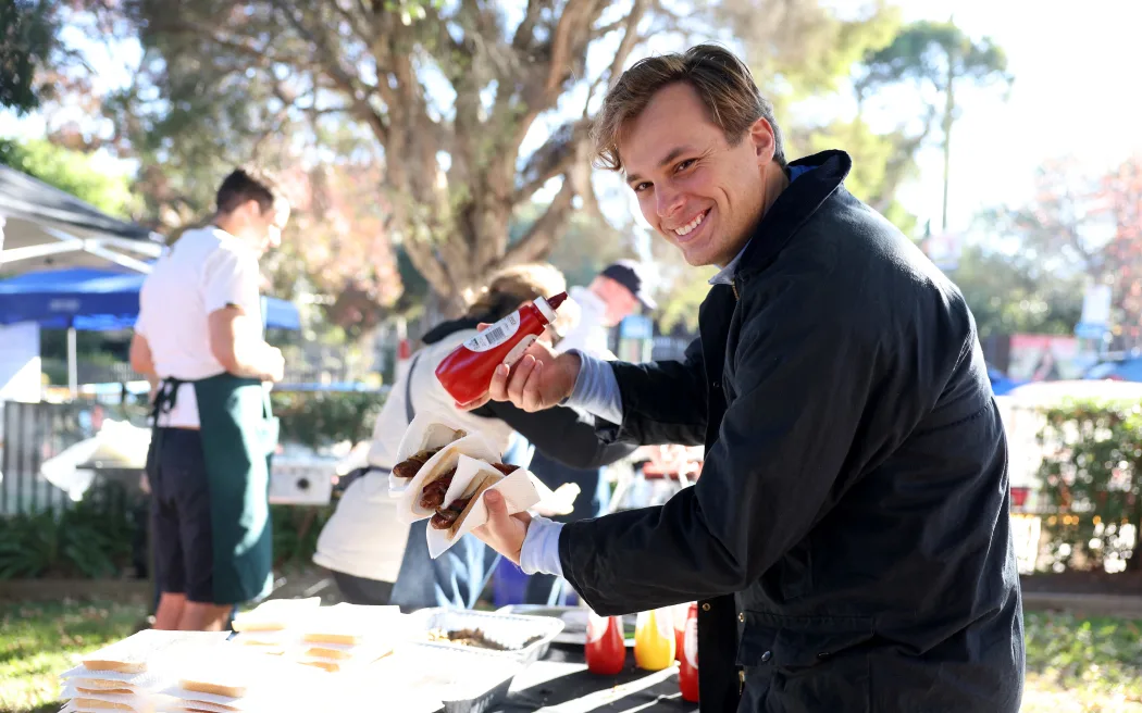 A voter enjoys a sausage, known informally as 