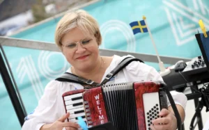 A woman plays the accordion at the opening date announcement of IKEA's first New Zealand store.