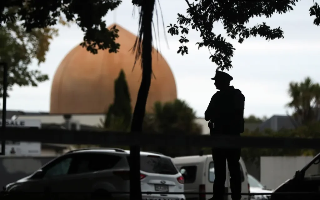 An armed policeman stands guard in front of the Masjid Al Noor Mosque in Christchurch on March 16, 2019. (Photo by MICHAEL BRADLEY / AFP)