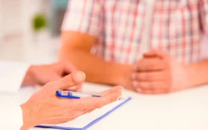 A doctor gives a male patient an update on his case (file photo)
