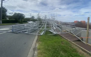 Dashcam footage show cars forced to swerve out of the way as the scaffolding bends, piece by piece, before collapsing into a pile across the road.