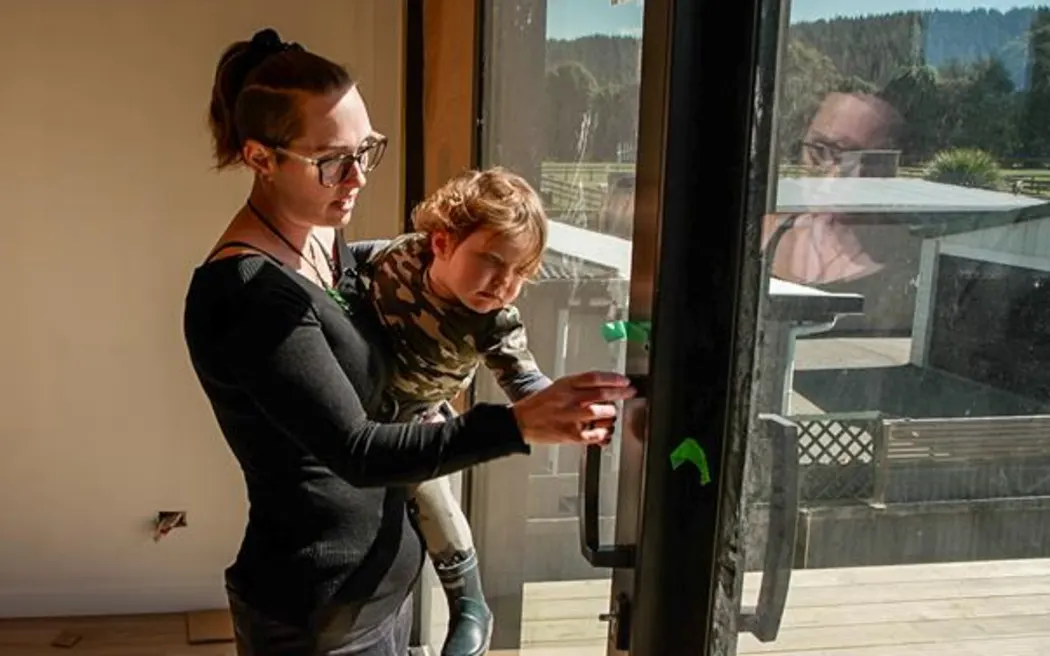 Ella Collins shows son Jack Jnr around their new Eskdale house.