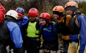 Year 11 Outdoor Ed students from Ellesmere College getting a river crossing pep-talk from their instructor.