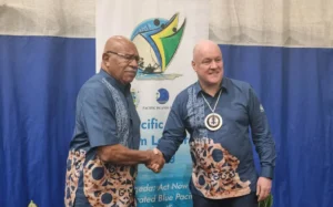 Fijian prime minister Sitiveni Rabuka shakes hands with Christopher Luxon.