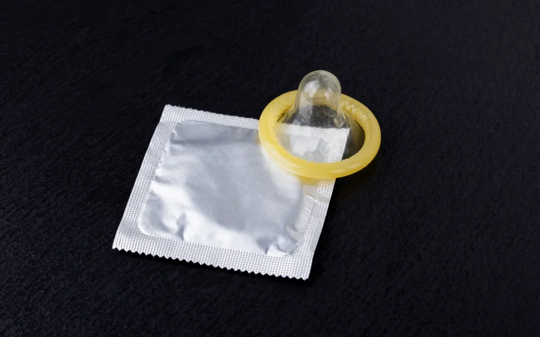 condom and pack on a black background