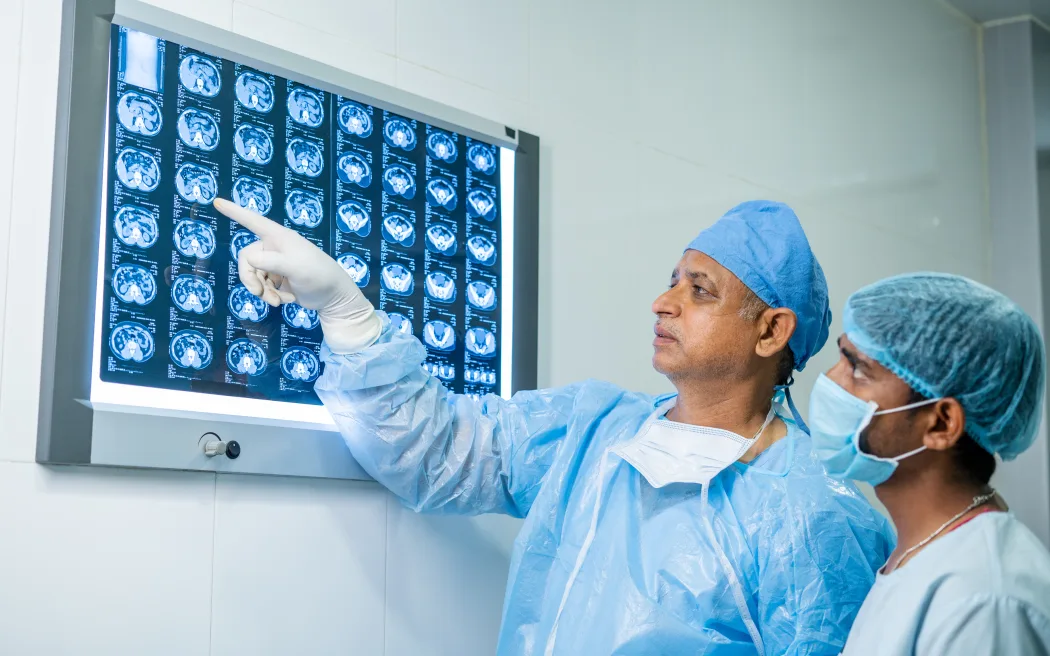 doctors in operation gown analysing x report before performing operation at hospital - concept of medical expertise, examining and medical care.