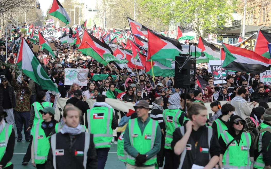 Pro-Palestine demonstrators make their way down Queen Street in Auckland, demanding the government impose sanctions on Israel.