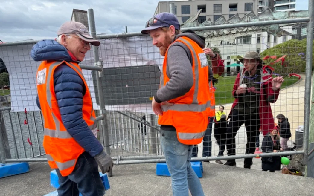 Protestors Alex Gray (left) and Iain Allan (right) on 13 September, 2025, preparing to remove one of the fences blocking access to the City to Sea Bridge.