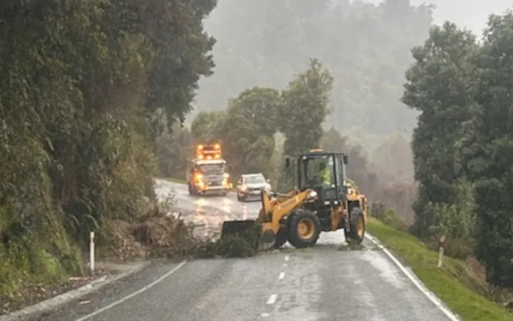 Rockfall from a slip is being cleared off the road near Jacksons on State Highway 73