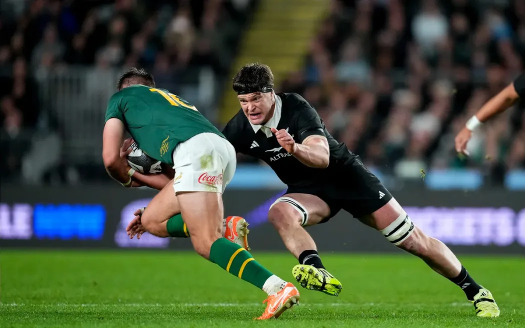 Scott Barrett makes a tackle on Handre Pollard.