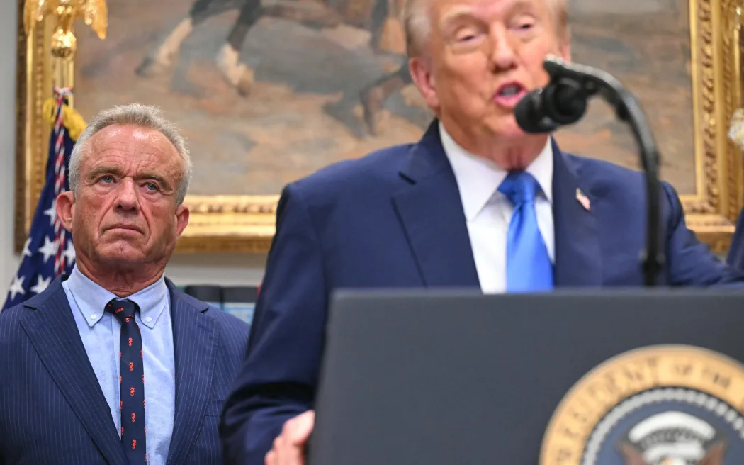 US President Donald Trump (R), alongside Secretary of Health and Human Services Robert F. Kennedy Jr. (L), speaks about autism in the Roosevelt Room of the White House in Washington, DC on September 22, 2025. (Photo by SAUL LOEB / AFP)