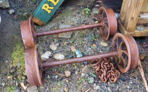 Caption: A man has been fined after attempting to steal artifacts including metal wheels, axles and a chain from the Denniston Mine on the West Coast. Credit: Supplied/Department of Conservation