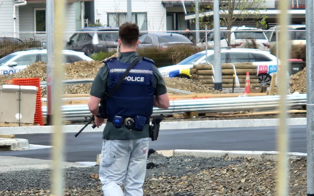 An armed police officer at the scene of a shooting in Flat Bush, Auckland.