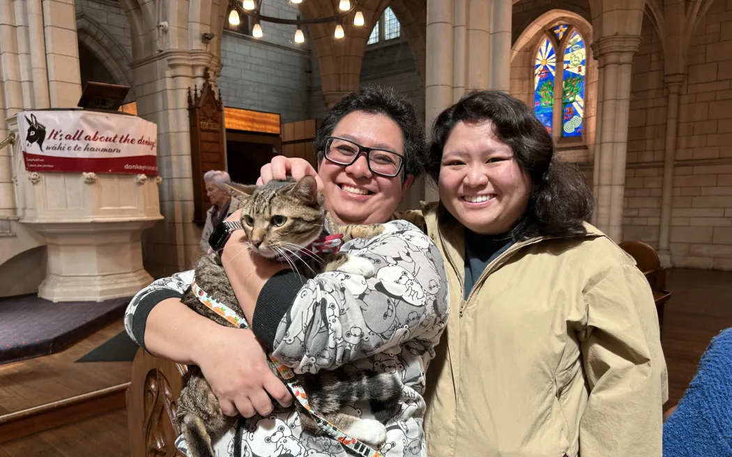 Portrait of two people with a cat.