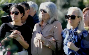 Carole Whorrall (centre) attends a service in memory of murdered son Kyle at St John's Reserve, Meadowbank.
