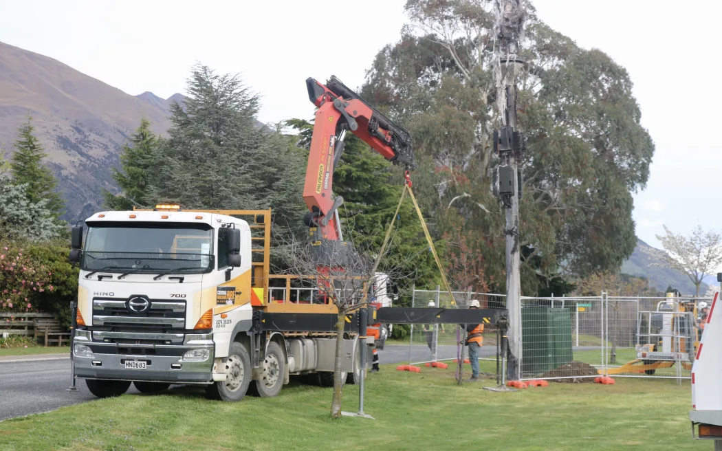 Contractors removing a destroyed One NZ cellphone communications tower in Wānaka on Friday 10 October, 2025, after it was vandalised.