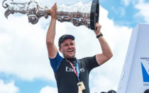 Cyclor Simon Van Velthooven holds up the America's Cup after Team New Zealand's victory in Bermuda in 2017, 26 June 2017. Copyright photo: Chris Cameron / www.photosport.nz
