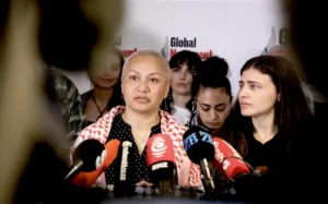 Green Party co-leaders Chlöe Swarbrick and Marama Davidson hold a media stand-up alongside family members of the New Zealanders aboard the flotilla.