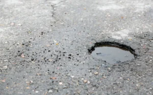 Broken asphalt close up. pothole generic