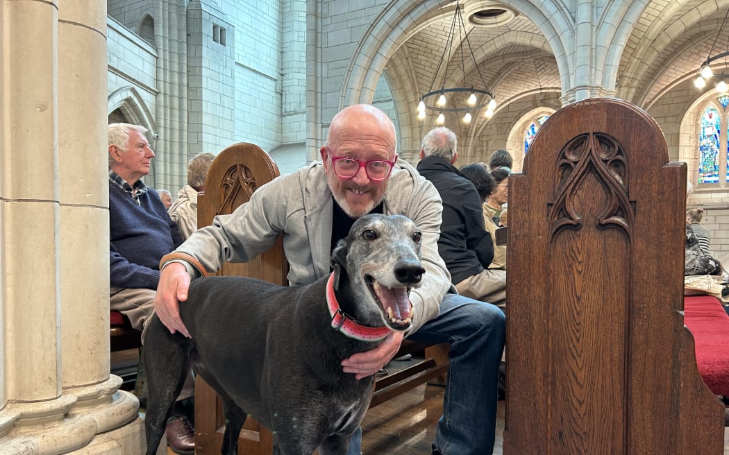 Portrait of a man and a Greyhound dog.