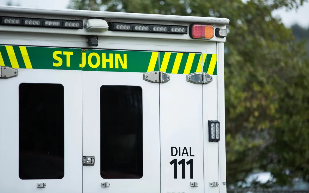 Close up of a St John ambulance on a residential street.