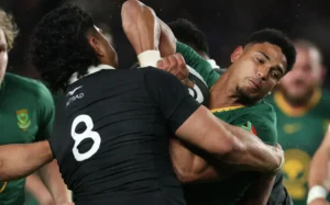 Sacha Feinberg-Mngomezulu of South Africa is tackled by Wallace Sititi, 2025
