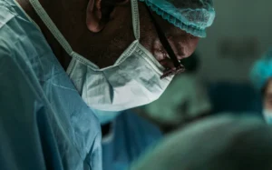 A doctor works on a patient in a surgery.