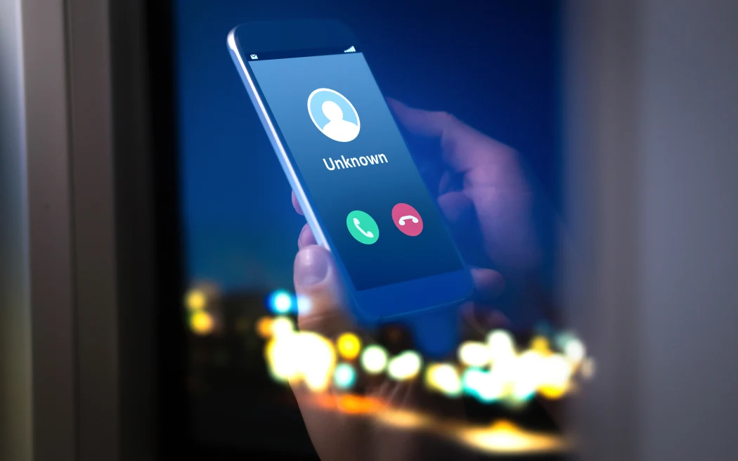 Unknown number calling in the middle of the night. Phone call from stranger. Person holding mobile and smartphone home late.