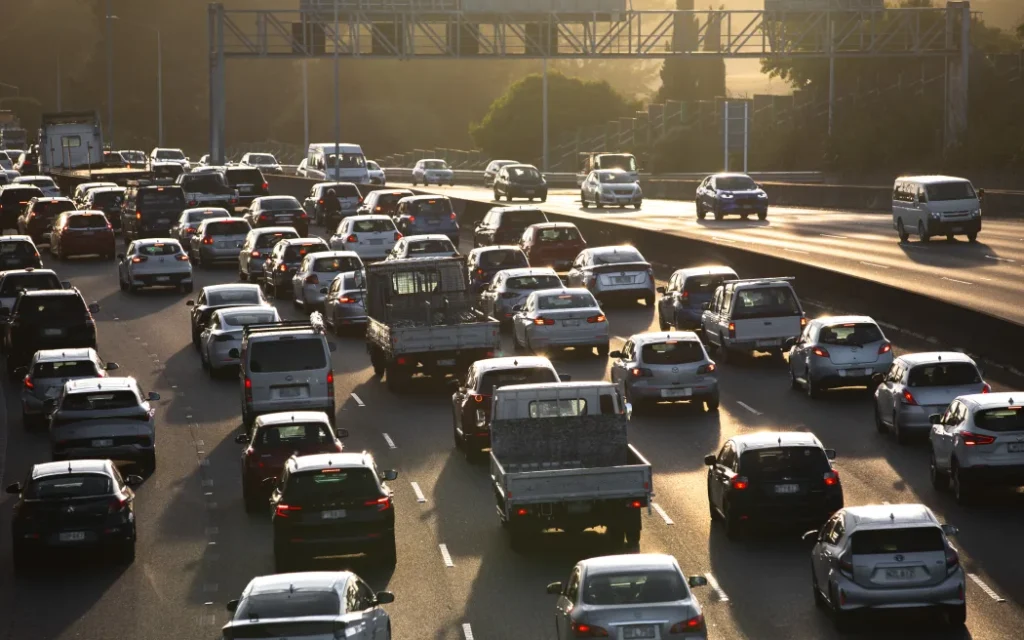 State Highway 16 full of slow moving morning traffic as the sun rises.
