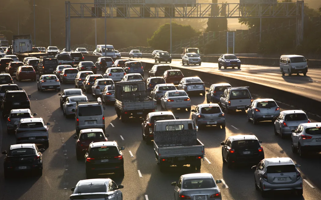 State Highway 16 full of slow moving morning traffic as the sun rises.