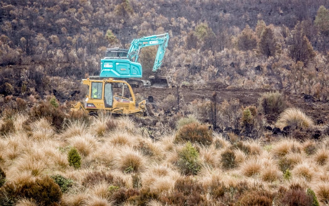 Diggers at work at the site of the fire in Tongariro