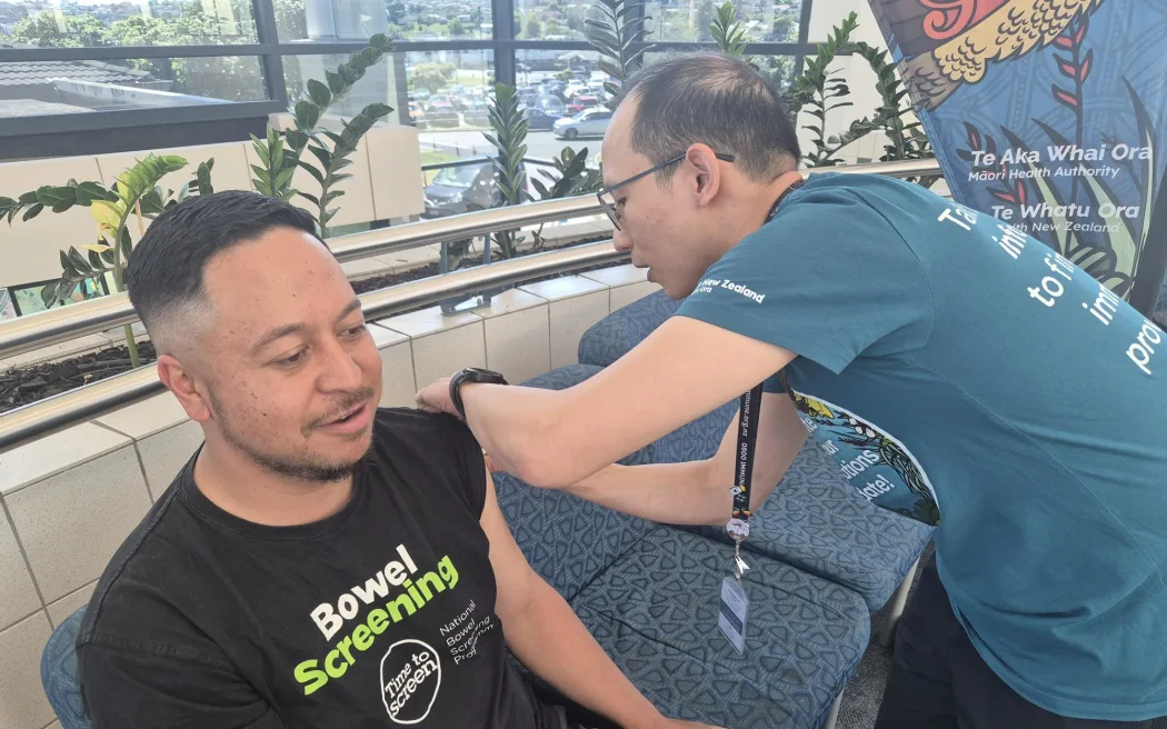 Kollin Hilihetule getting vaccinated at a pop-up clinic in Manukau