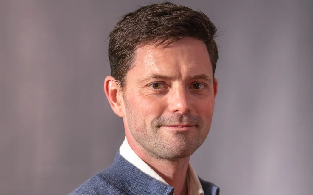 Nark: Tự do sớm, tiền bạc, chỗ ở - Nhân chứng vụ án mạng trong tù khẳng định không nói dối 4 Image of Mike Wesley-Smith smiling at the camera in front of a grey background.