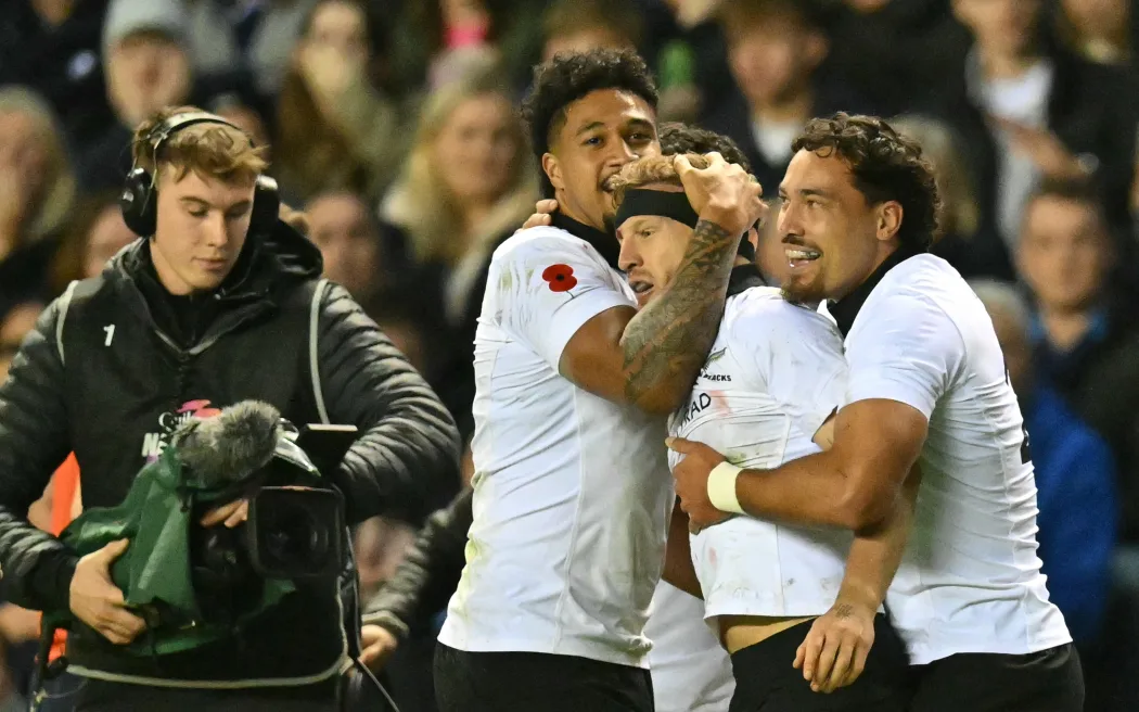 New Zealand's Damian McKenzie celebrates scoring a try against Scotland.