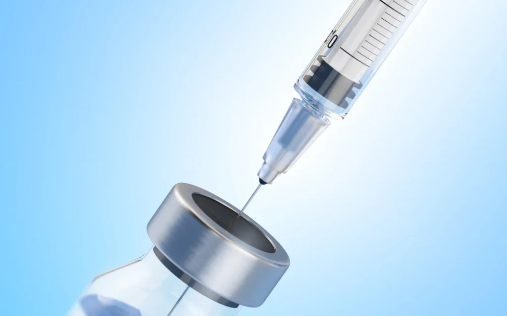 Syringe in phial, illustration. (Photo by SERGII IAREMENKO/SCIENCE PHOTO L / SIA / Science Photo Library via AFP)