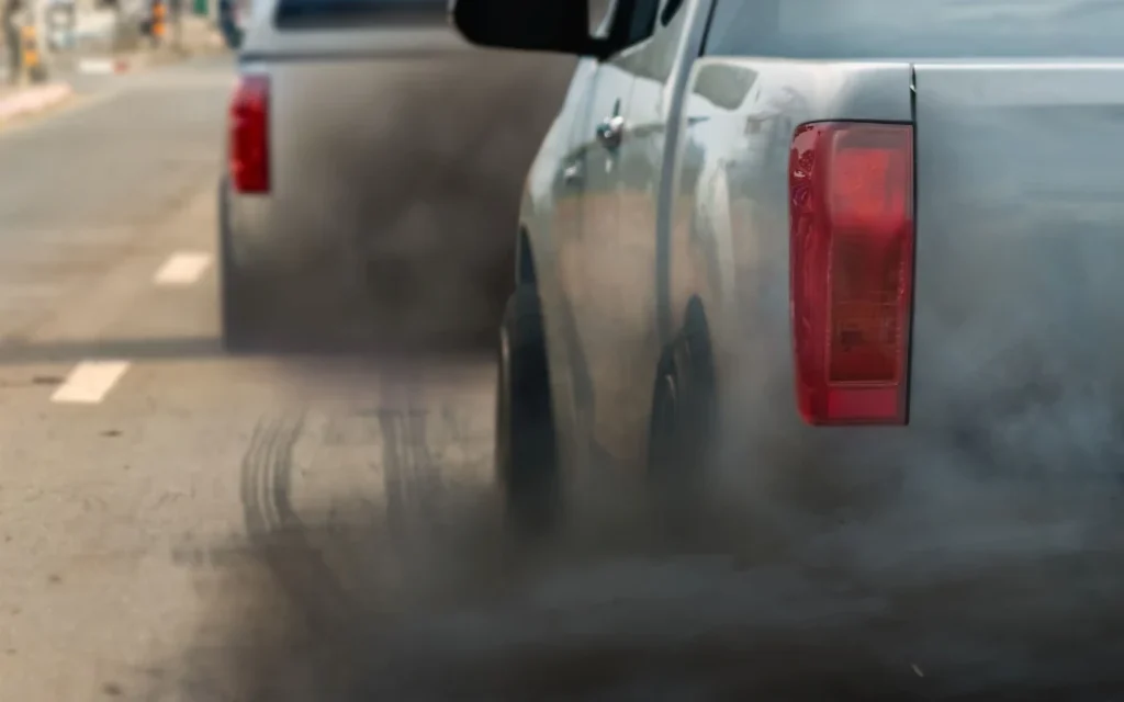 air pollution crisis in city from diesel vehicle exhaust pipe on road