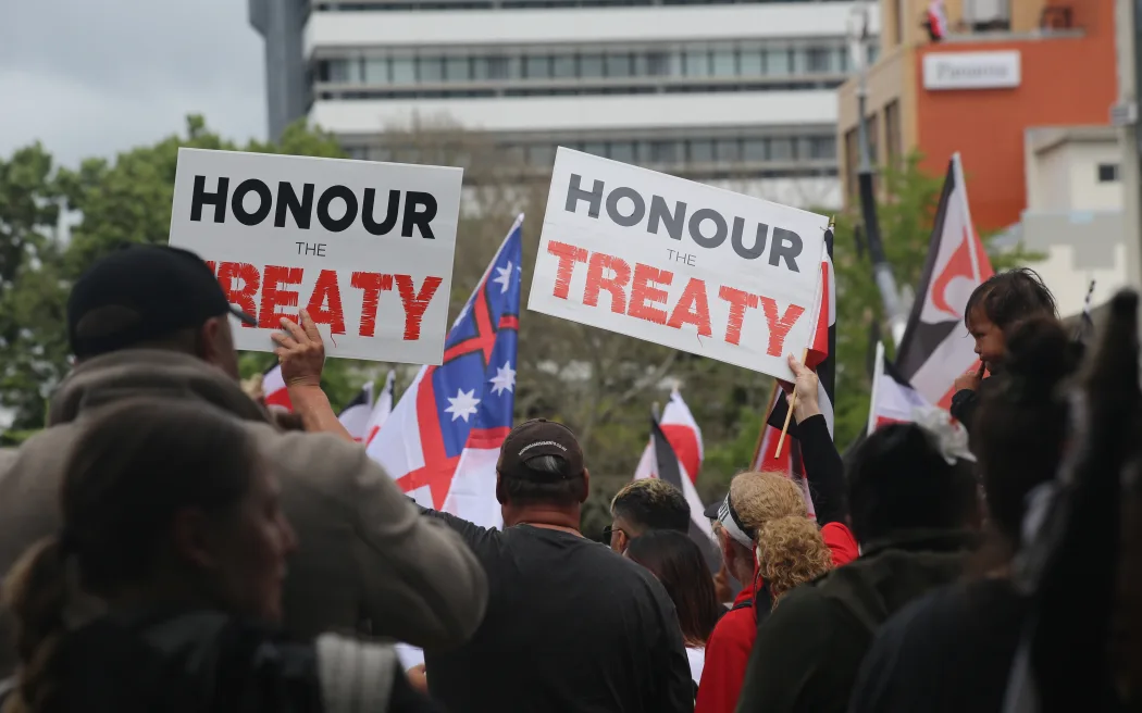Supporters in Hamilton holding signs that read 'Honour the Treaty.'