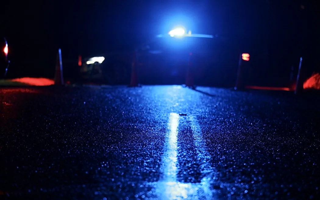 A police car parked across the road at the scene of a triple fatality in Waiuku, in July 2025.