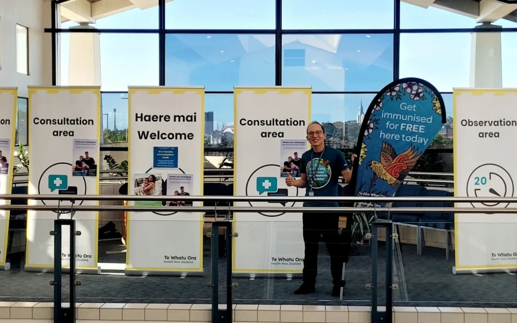 Public Health pharmacist and outreach vaccinator Christopher Leung, setting up the measles pop-up clinic at the Manukau Super Clinic.