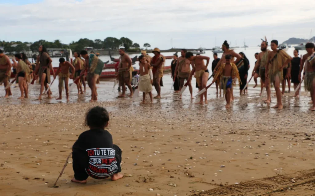 Tamariki, Raupatu Hetaraka from Ngāti Kahu watching the kaihoe at Waitangi Day 2025.