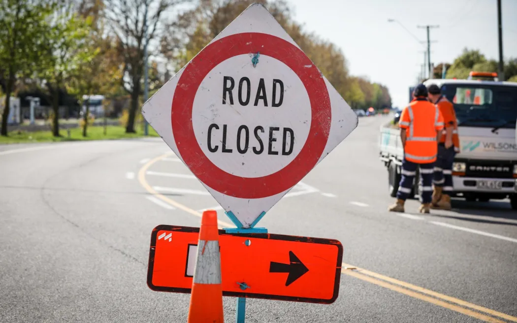 A road closed detour sign.
