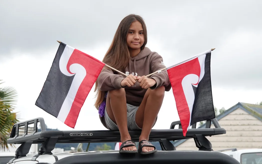 Tahlia, 10, has made sure she's got the best view as the hikoi arrives in Kawakawa.